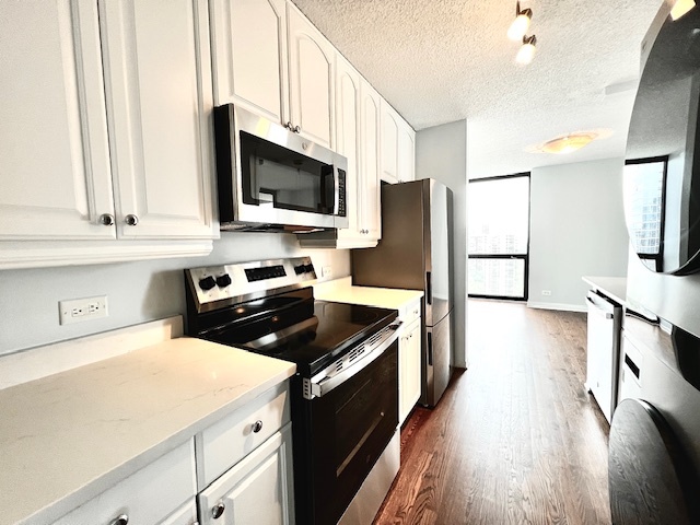1122 North Clark Street, Unit 2806 Chicago, IL 60610 - Photo 10 of 20 a kitchen with a sink a microwave a stove and refrigerator