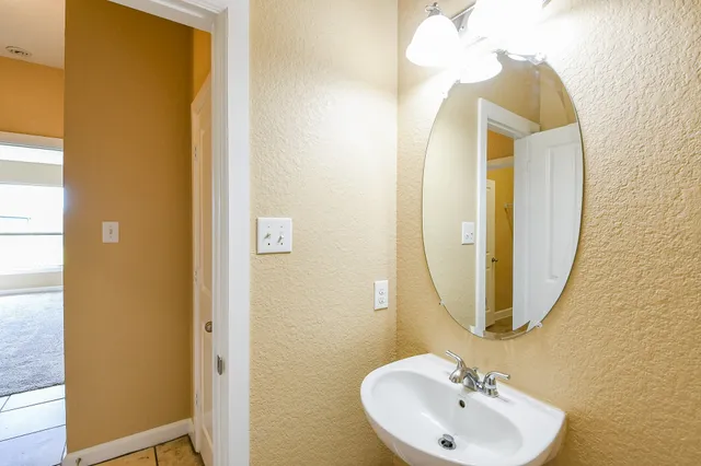 a bathroom with a sink and a mirror