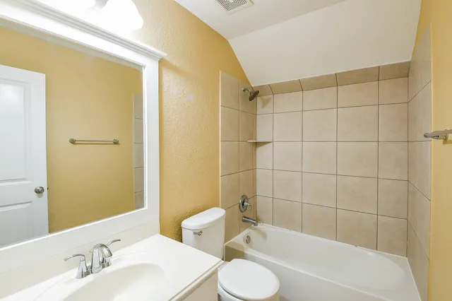 a bathroom with a toilet a sink and bathtub