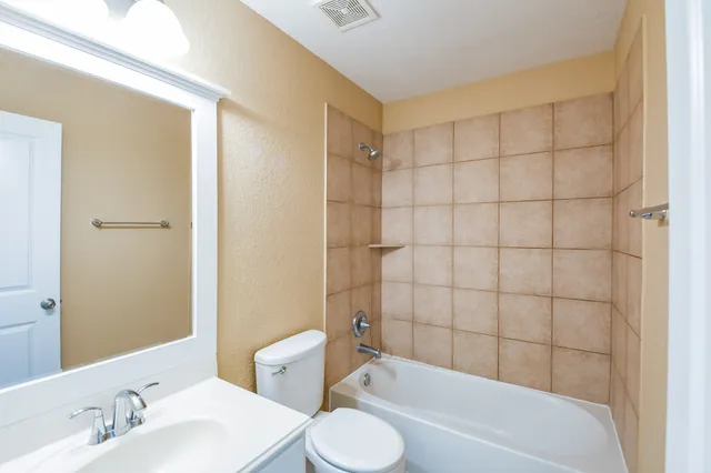 a bathroom with a sink toilet and bathtub