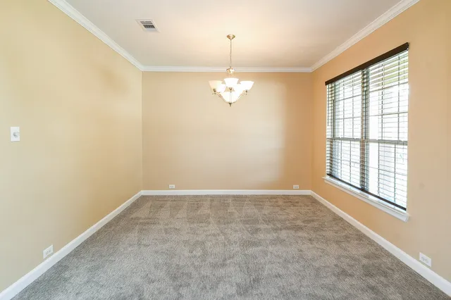 an empty room with windows and entrance