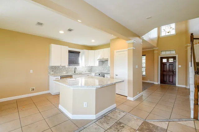 a kitchen with a sink a counter top space and stainless steel appliances