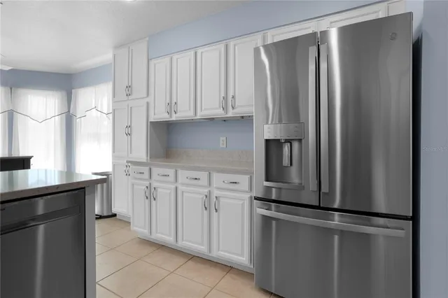 a kitchen with stainless steel appliances granite countertop a refrigerator and a stove