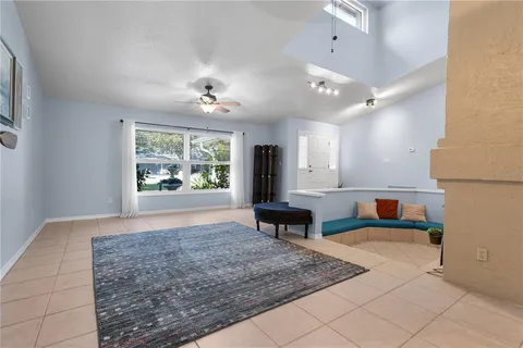 wooden floor in a hall with a window and a couch