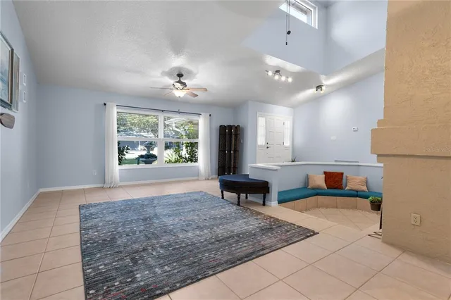 wooden floor in a hall with a window and a couch