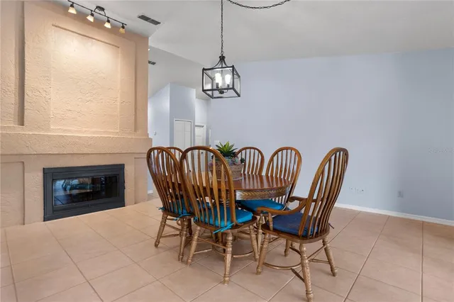 a view of a dining room with furniture wooden floor and a chandelier