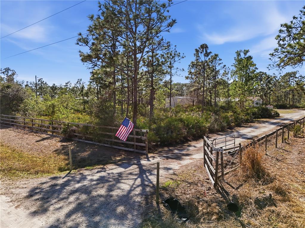 6844 Chad Jason Road St. Cloud, FL 34773 - Photo 52 of 59 a backyard of a house with table and chairs
