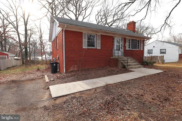 a view of a house with a yard covered in snow