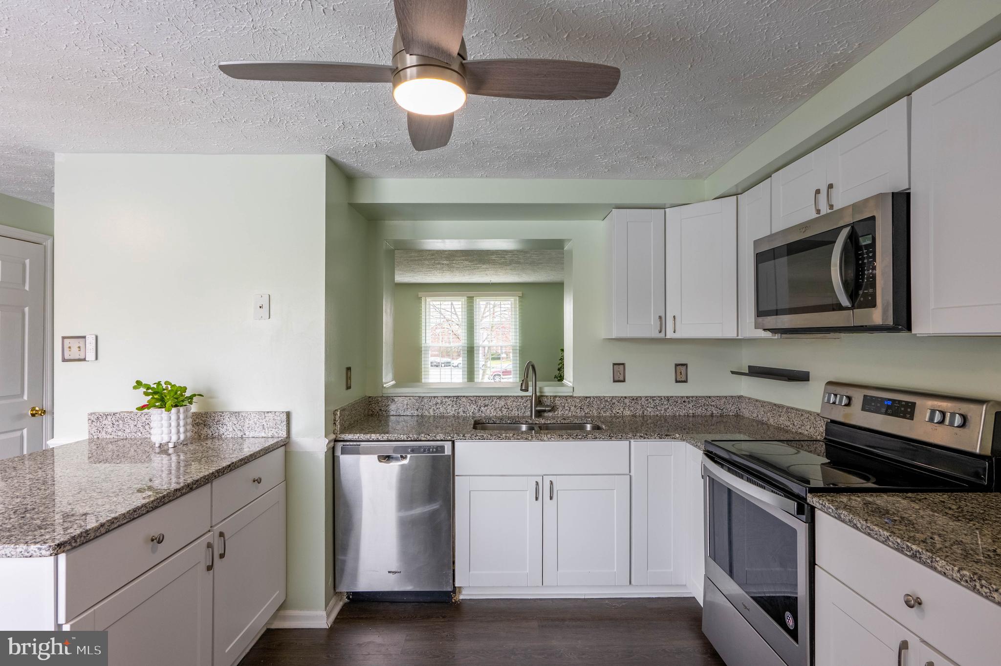 27 Cavan Green Nottingham, MD 21236 - Photo 13 of 31 a kitchen with granite countertop a sink stainless steel appliances and white cabinets