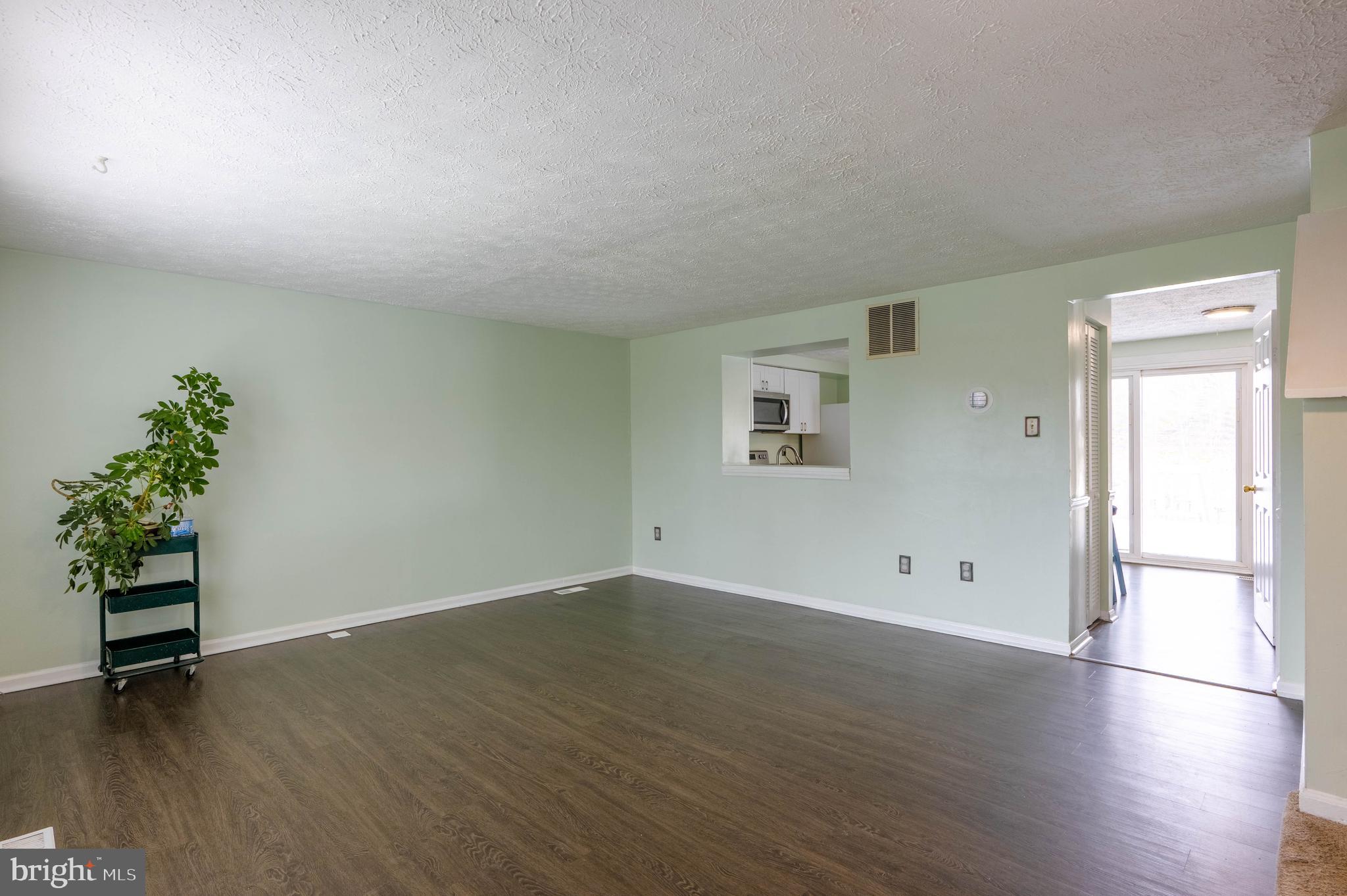 27 Cavan Green Nottingham, MD 21236 - Photo 6 of 31 an empty room with wooden floor and windows