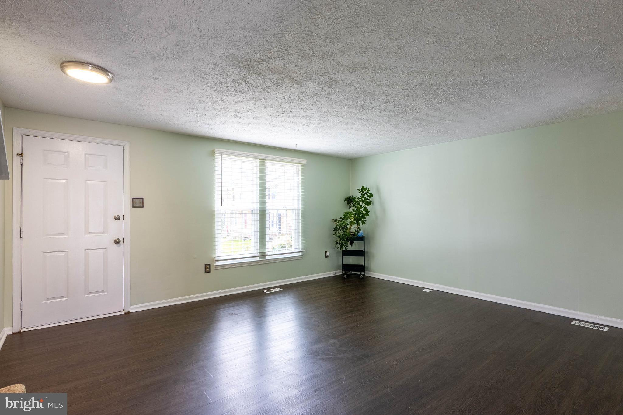 27 Cavan Green Nottingham, MD 21236 - Photo 9 of 31 an empty room with wooden floor and windows