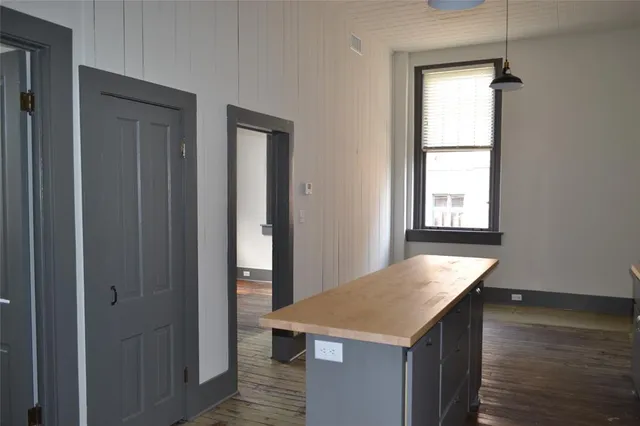 a kitchen with a wooden floor and window