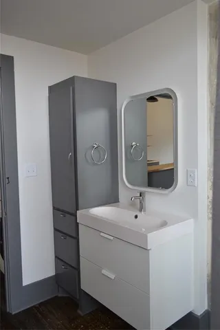 a bathroom with a sink and mirror