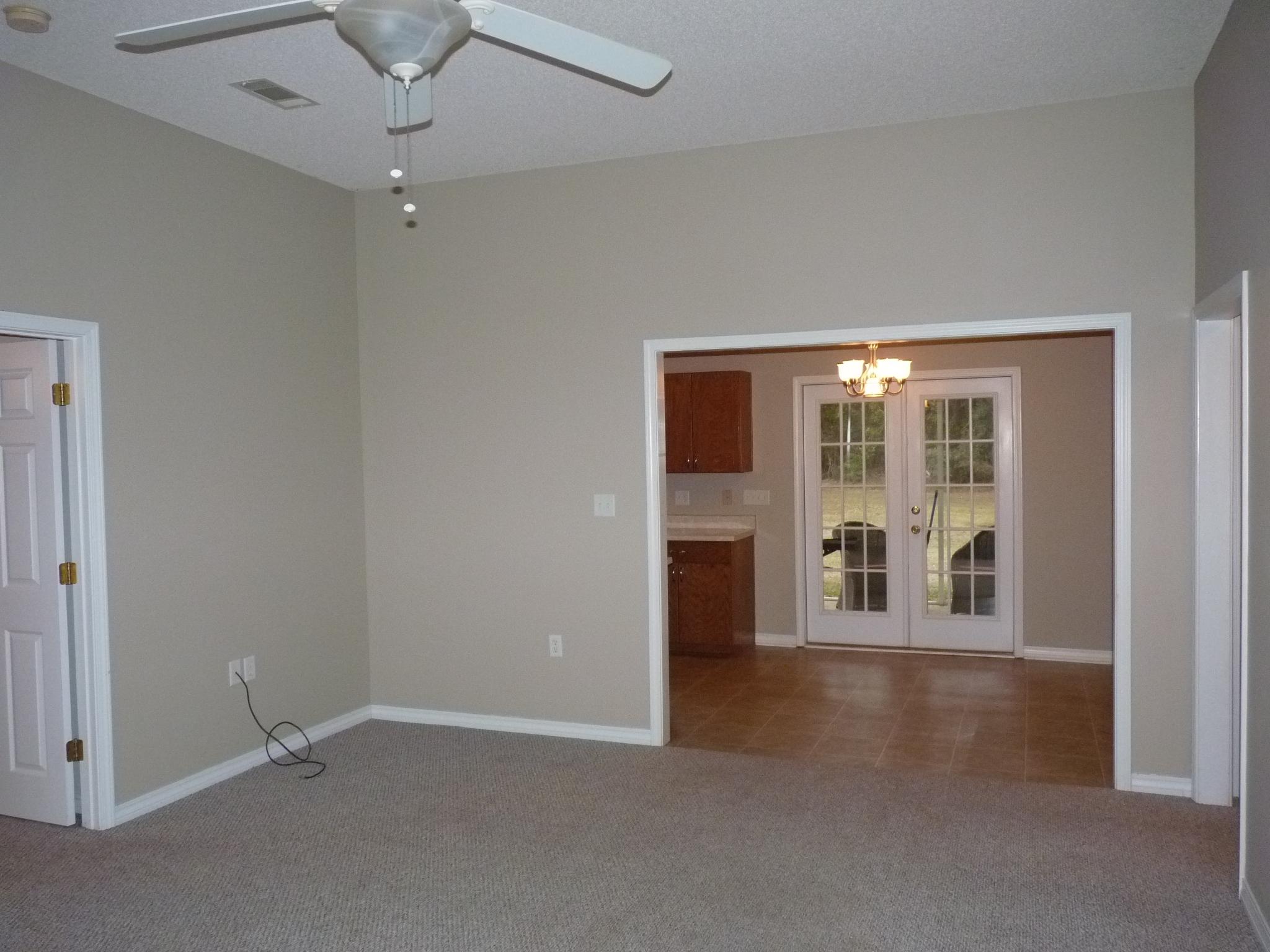 5814 Dairy Road Baker, FL 32531 - Photo 4 of 29 an empty room with a fireplace and a window