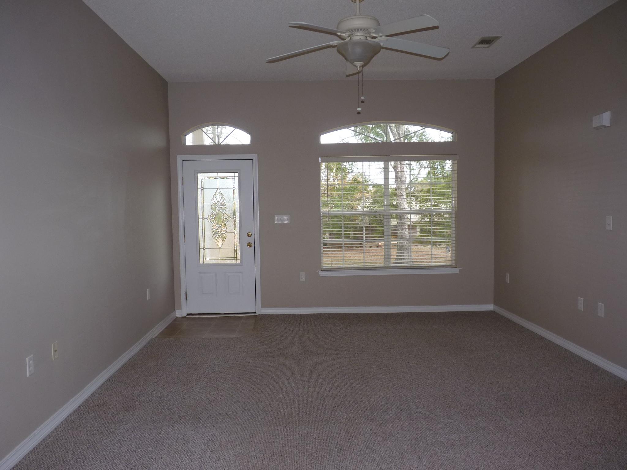 5814 Dairy Road Baker, FL 32531 - Photo 6 of 29 an empty room with windows and fan