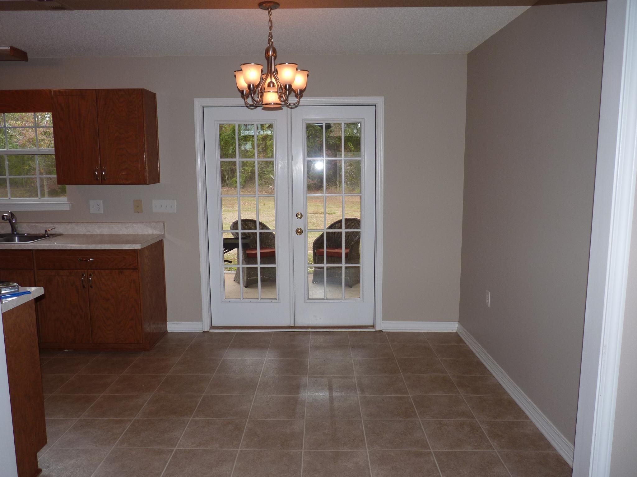 5814 Dairy Road Baker, FL 32531 - Photo 7 of 29 a view of livingroom with chandelier and kitchen view