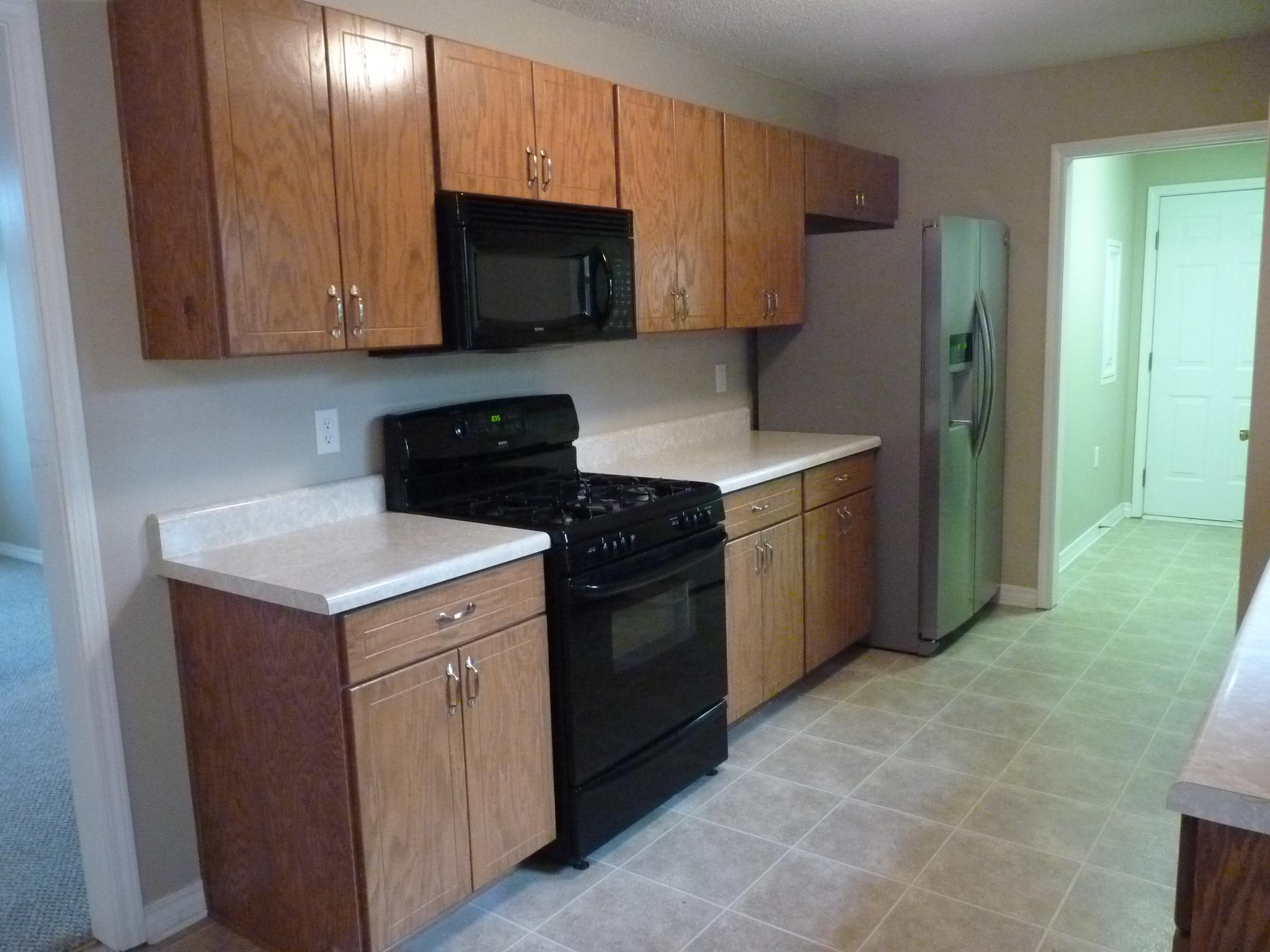 5814 Dairy Road Baker, FL 32531 - Photo 9 of 29 a kitchen with a sink stove and microwave