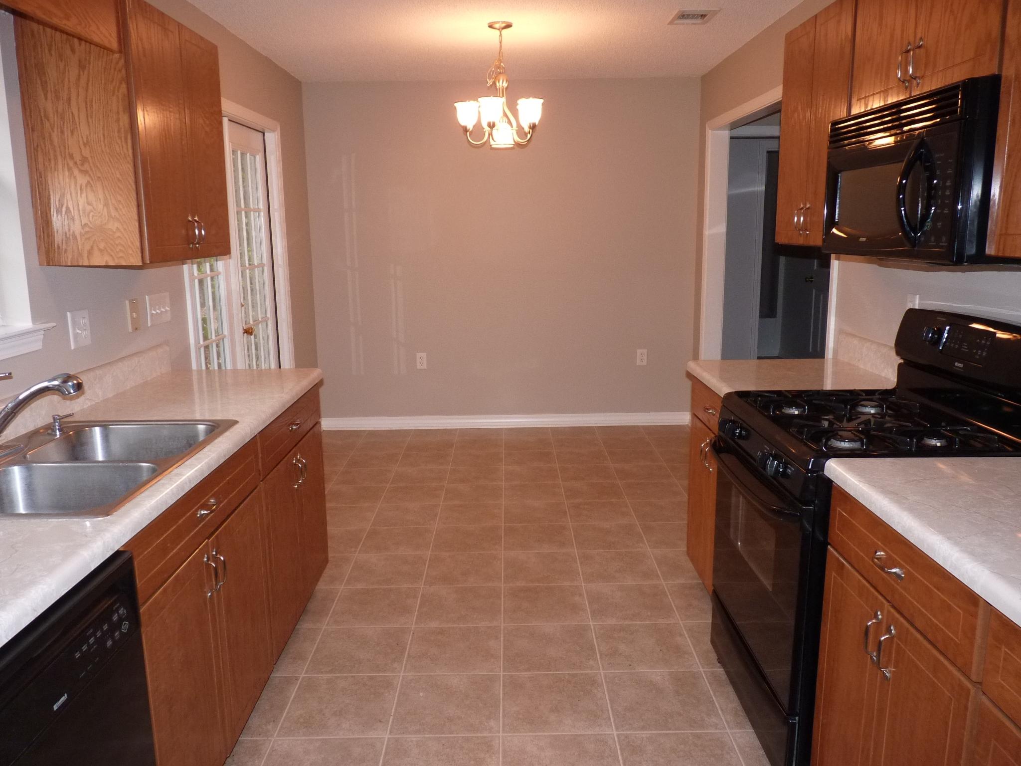 5814 Dairy Road Baker, FL 32531 - Photo 10 of 29 a kitchen with a sink stove and cabinets