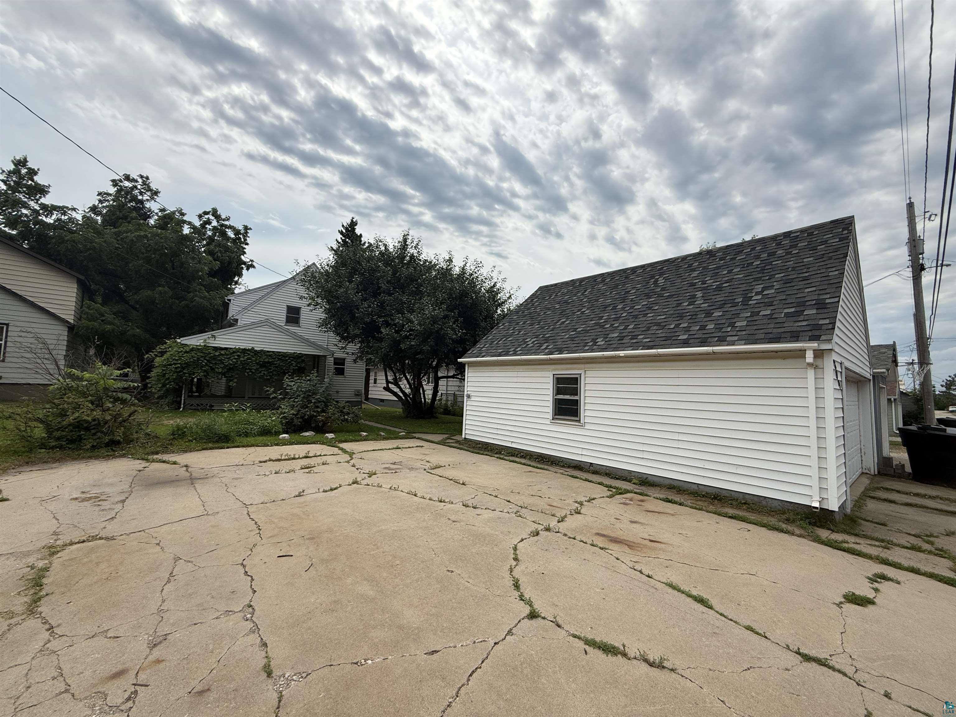 809 16th Street North Virginia, MN 55792 - Photo 44 of 44 View of patio featuring an outbuilding and a garage