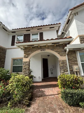 a kitchen with kitchen island a counter top space a sink and refrigerator