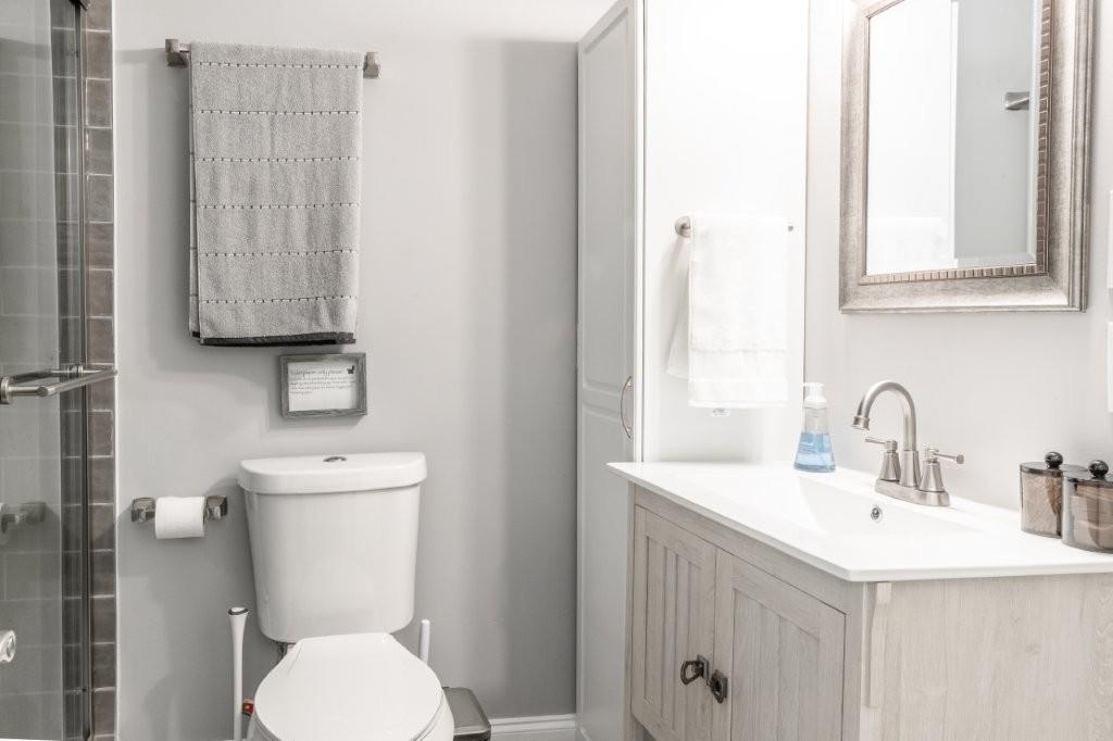 1944 Wilderness Parkway Jasper, GA 30143 - Photo 15 of 26 a bathroom with a toilet sink and mirror