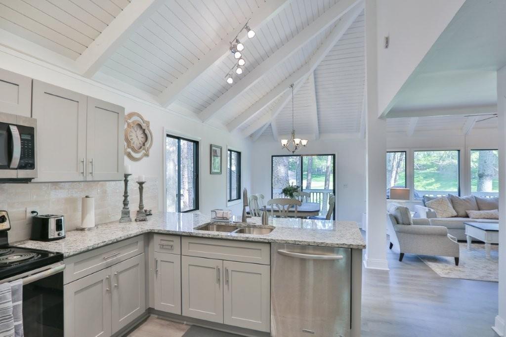 1944 Wilderness Parkway Jasper, GA 30143 - Photo 4 of 26 a kitchen with stainless steel appliances granite countertop a lot of counter space and a sink