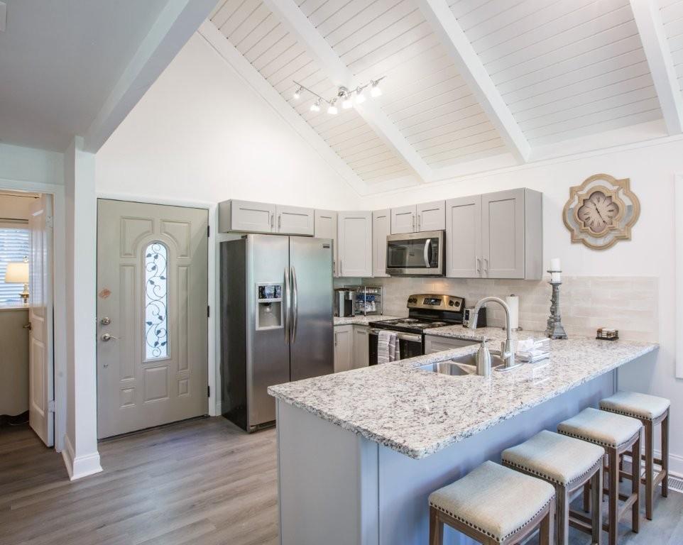 1944 Wilderness Parkway Jasper, GA 30143 - Photo 5 of 26 a kitchen with stainless steel appliances granite countertop a sink refrigerator stove and microwave