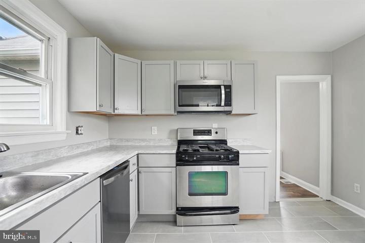1239 Hilldale Road Baltimore, MD 21237 - Photo 2 of 13 a kitchen with a sink a stove and cabinets