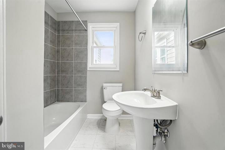 1239 Hilldale Road Baltimore, MD 21237 - Photo 7 of 13 a bathroom with a sink toilet and shower
