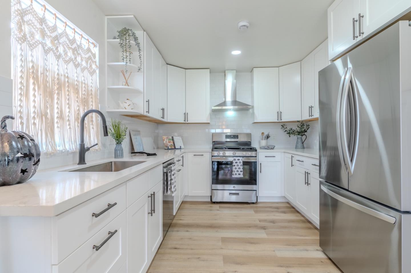 1324 Peralta Road Pacifica, CA 94044 - Photo 12 of 35 a kitchen with stainless steel appliances a refrigerator sink and cabinets