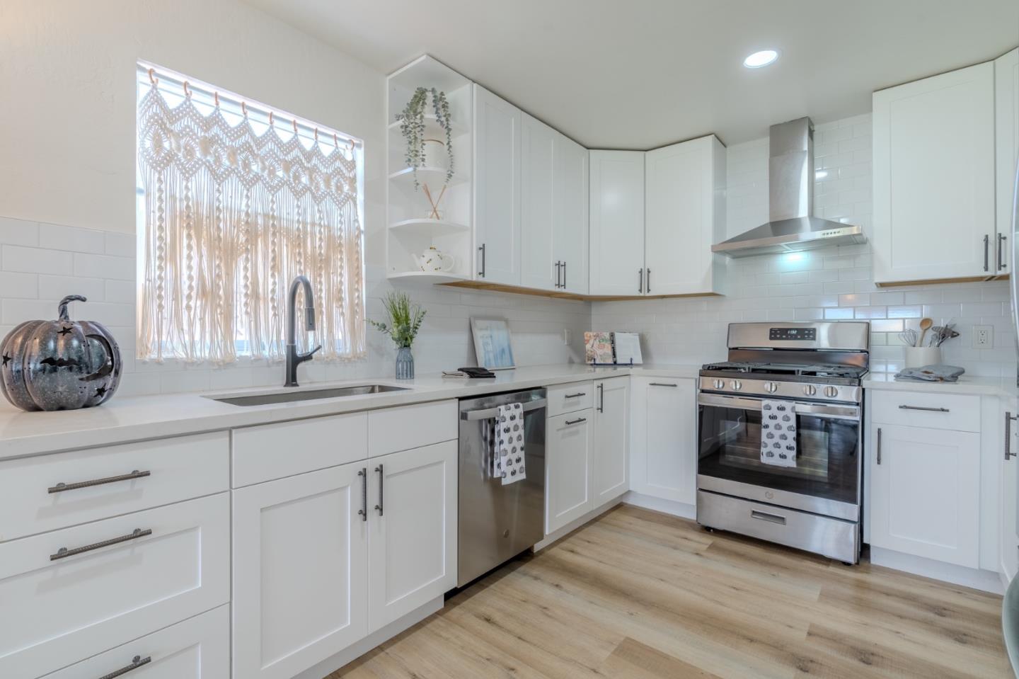 1324 Peralta Road Pacifica, CA 94044 - Photo 13 of 35 a kitchen with granite countertop white cabinets and white stainless steel appliances