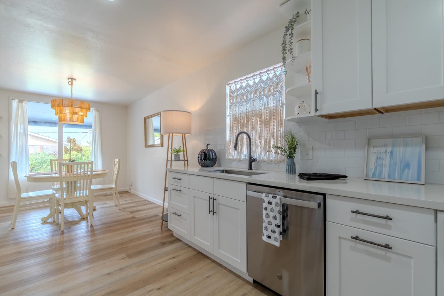 1324 Peralta Road Pacifica, CA 94044 - Photo 15 of 35 a kitchen with white cabinets and wooden floor