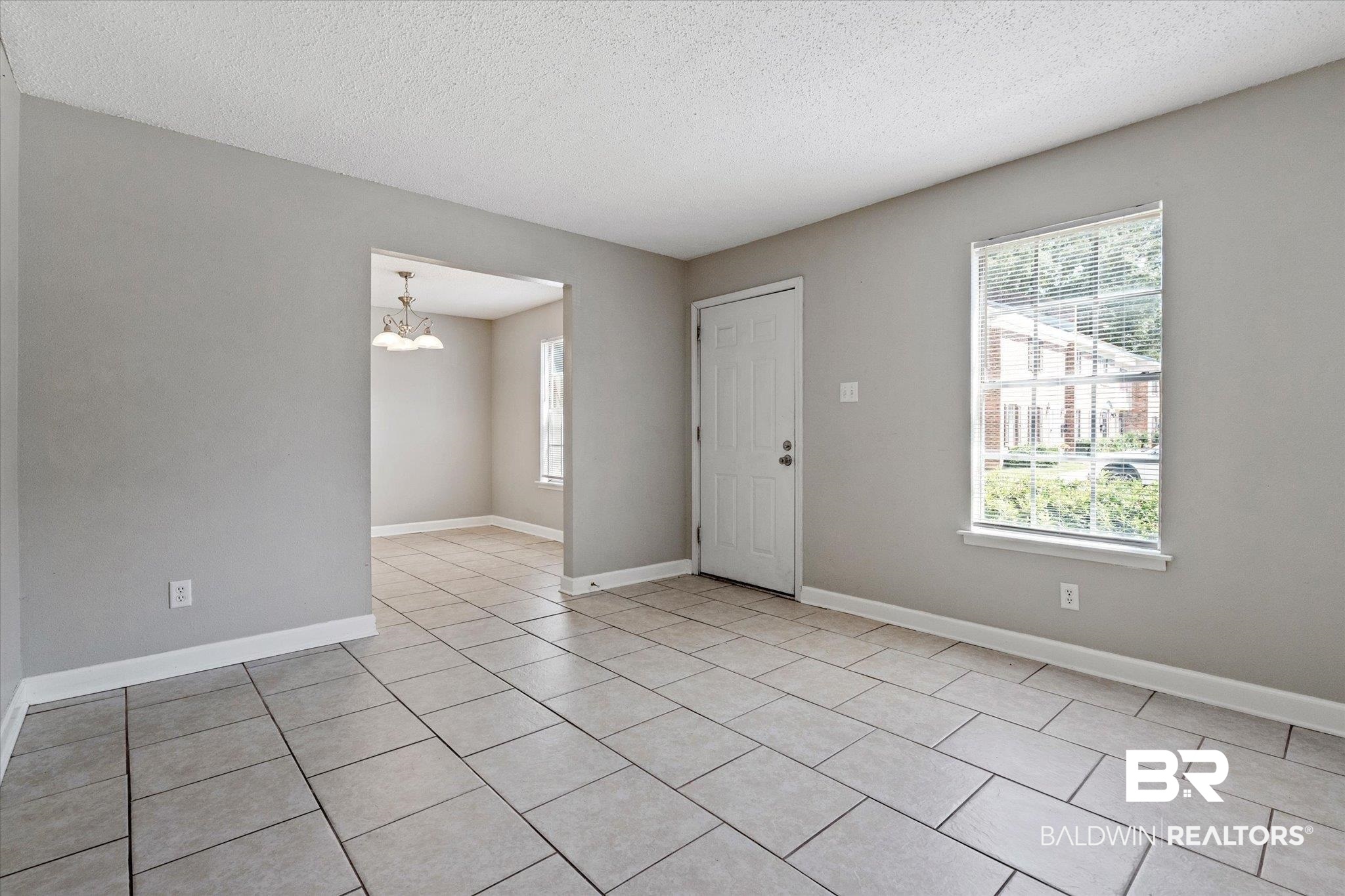 4017 Cottage Hill Road, Unit 59 Mobile, AL 36609 - Photo 3 of 25 Tiled spare room with a textured ceiling and a chandelier