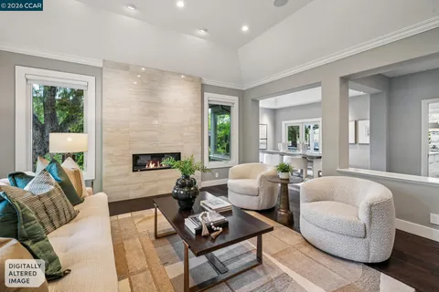 a living room with furniture fireplace and a large window