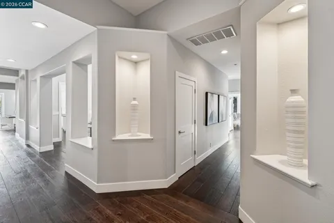 a spacious bathroom with double sink a mirror a vanity and a shower
