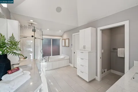 a bedroom with a bed and a closet with mirror
