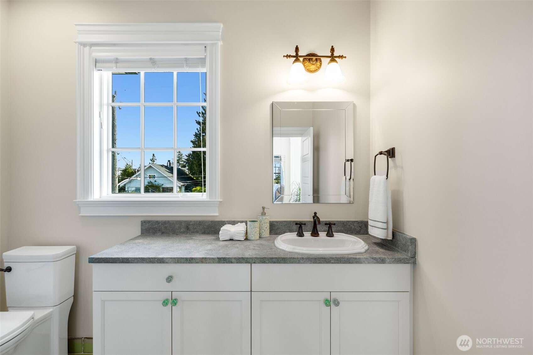 3723 41st Avenue Southwest Seattle, WA 98116 - Photo 25 of 40 a bathroom with a sink and a mirror