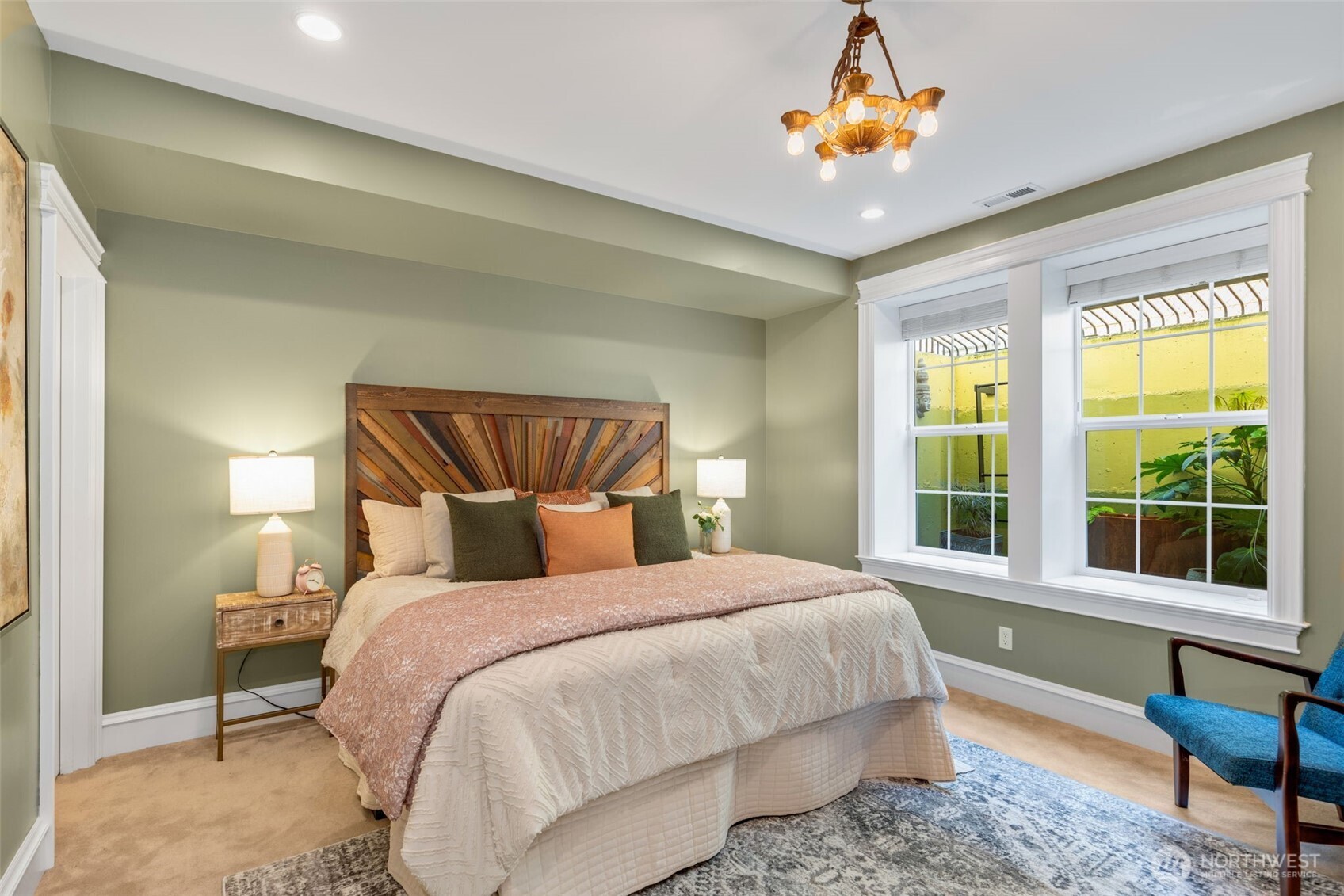 3723 41st Avenue Southwest Seattle, WA 98116 - Photo 33 of 40 a bedroom with a large bed and a chandelier