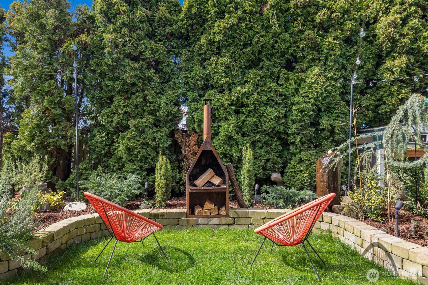 3723 41st Avenue Southwest Seattle, WA 98116 - Photo 39 of 40 a backyard of a house with table and chairs