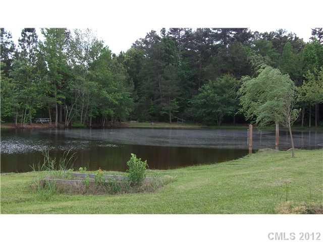 1311 East Sandy Ridge Road Monroe, NC 28112 - Photo 3 of 13 a black and white photo of a lake