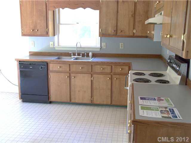 1311 East Sandy Ridge Road Monroe, NC 28112 - Photo 5 of 13 a kitchen with stainless steel appliances granite countertop a sink a stove and a refrigerator