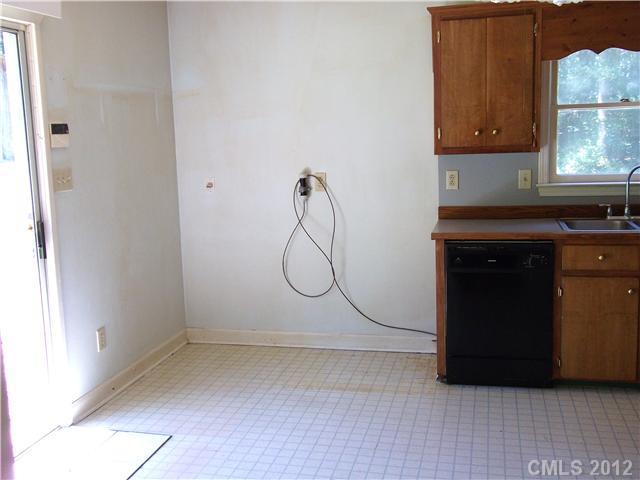 1311 East Sandy Ridge Road Monroe, NC 28112 - Photo 6 of 13 a bathroom with a granite countertop shower a sink and a window