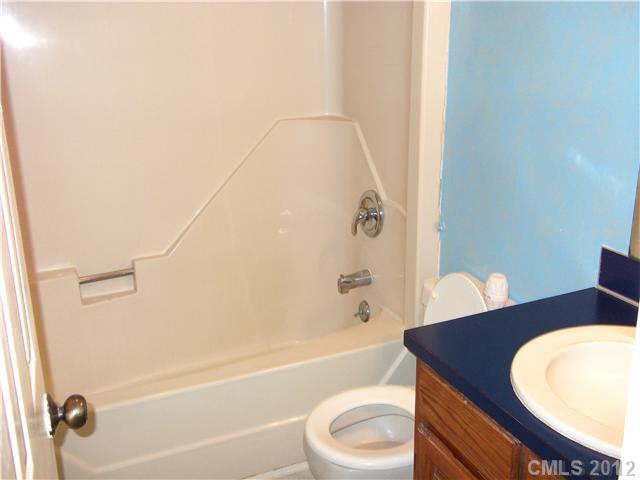 1311 East Sandy Ridge Road Monroe, NC 28112 - Photo 8 of 13 a bathroom with a sink a toilet and bathtub