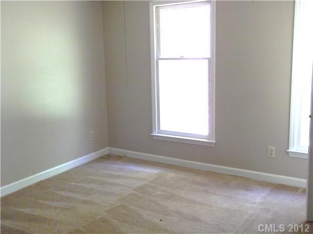 1311 East Sandy Ridge Road Monroe, NC 28112 - Photo 9 of 13 an empty room with a window