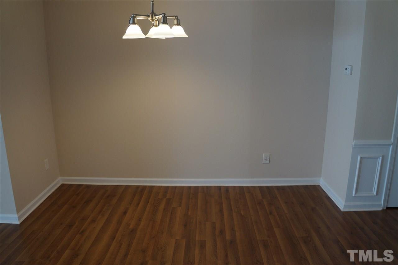 7036 Racine Way Raleigh, NC 27615 - Photo 11 of 22 a view of a room with wooden floor cabinets and a window