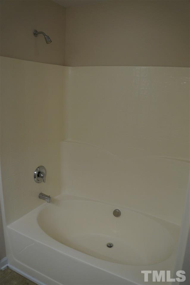 7036 Racine Way Raleigh, NC 27615 - Photo 17 of 22 a bathroom with a bathtub