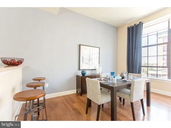 a dining room with furniture and window