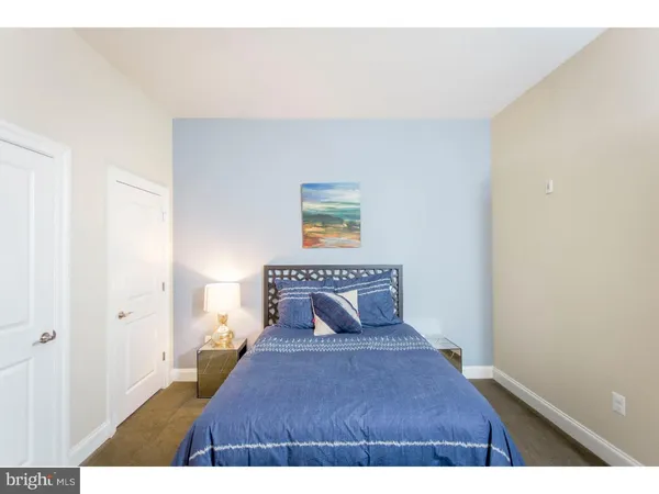 a bedroom with a bed and a painting