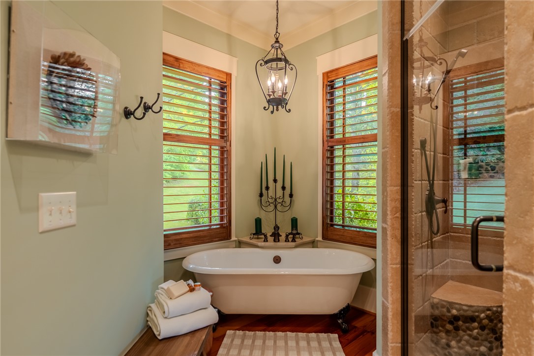 102 State Rd S-39-143 Sunset, SC 29685 - Photo 30 of 47 This primary bathroom features a standalone tub and a glass-enclosed shower for ultimate comfort.