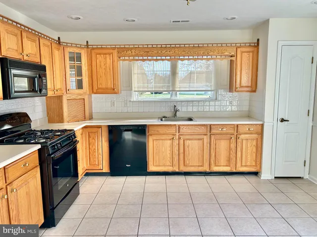 a kitchen with stainless steel appliances granite countertop a refrigerator and a stove
